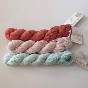 3 skeins of 100% organic cotton yarn: pink, orange, light green